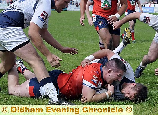 Liam Gilchrist dives over for Oldham’s third try.