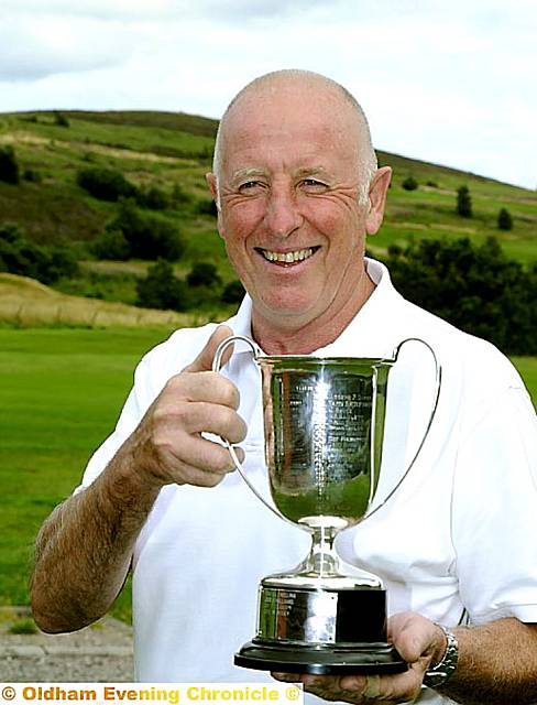 JUST CHAMPION . . . Richard Hughes shows off his trophy 