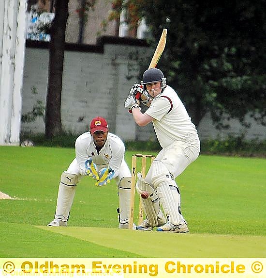 PREPARING TO STRIKE: Werneth captain Matt Taylor winds up from a delivery from Crompton’s Carl Taylor (main). 