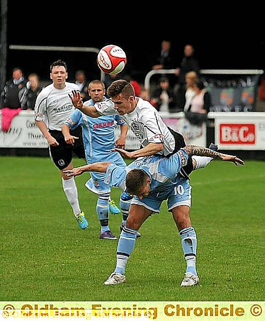 up and over: James Blair, of Mossley, beats his Kendal Town opponent to the ball in the Evo-Stik Division One North opener at Seel Park. up and over: James Blair, of Mossley, beats his Kendal Town opponent to the ball in the Evo-Stik Division One North opener at Seel Park.