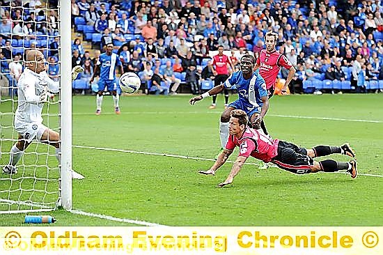 STOOP TO CONQUER: Charlie MacDonald dives to head home and give Athletic a glimmer of light in the closing stages at London Road.