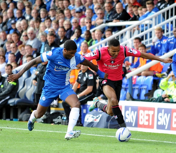 LATICS FLYER: Cristian Montano hugs the touchline at London Road: ‘You protect what you think is right. I may be 5ft 6in, but when I am like that I feel 7ft 6in’ said manager Johnson. 
