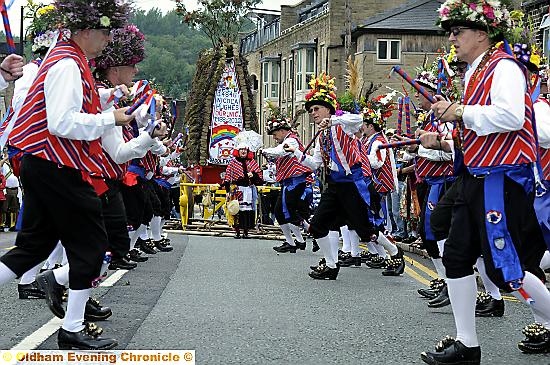 A CLICK of the clogs and off we go... Saddleworth Morris Men in full flow, with the rush cart in the background  

