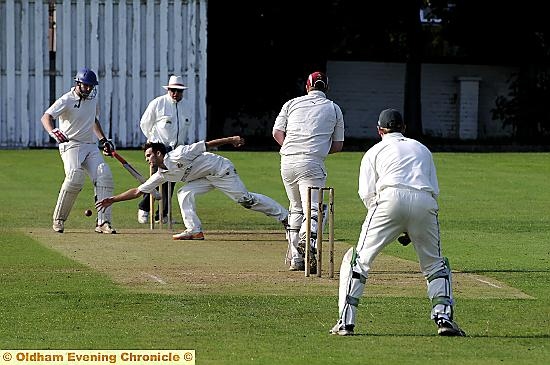 ONE-HANDED: Royton bowler Adam Good reaches for the ball after a shot from Werneth batsman Matt Taylor 
