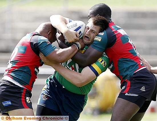 OLDHAM’S Phil Joy is caught in a headlock as he attempts to make ground. 