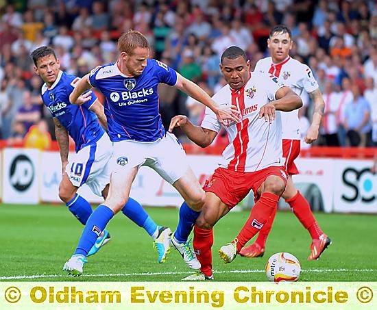 GET STUCK IN . . . Adam Rooney forages up front for Athletic. 