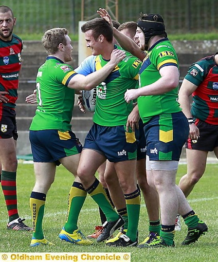 PLENTY TO SMILE ABOUT: Lewis Palfrey gets a pat on the back of the head after scoring a try in Oldham’s win at London Skolars. 