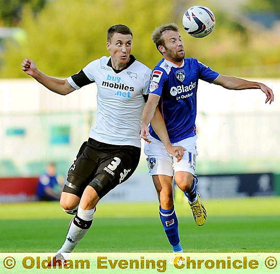 SHOULDER TO SHOULDER: Athletic’s James Dayton tries to bring the ball down under pressure from Craig Forsyth. 