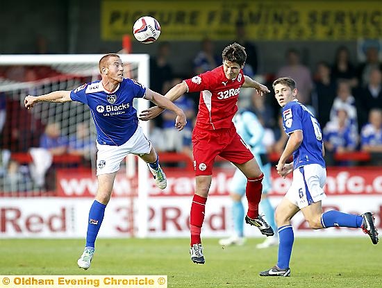 Adam Rooney wins a header at the expense of Josh Simpson. 