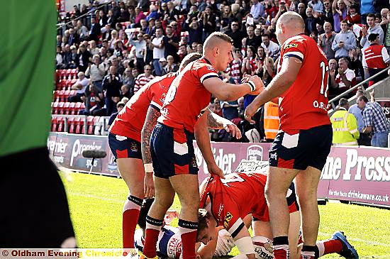 ON THE SCOREBOARD: Jon Ford gets a friendly tug on the shirt after diving in for the Roughyeds’ opening try at Leigh Sports Village. 
