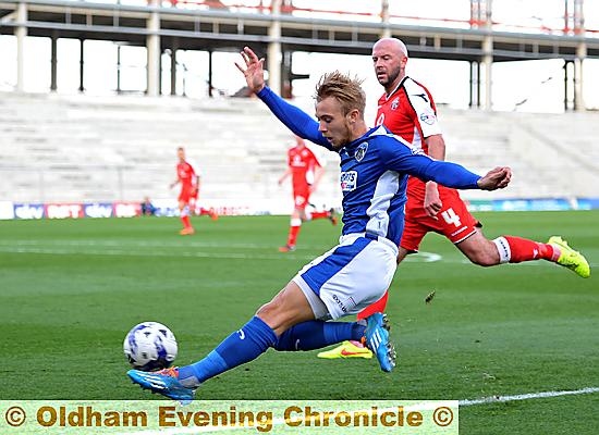 FULL STRETCH: Joseph Mills produces athleticism to provide a cross into the Walsall penalty box.