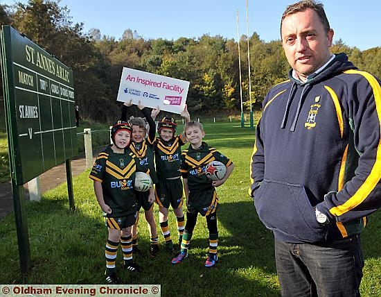 REASONS TO BE CHEERFUL: celebrating the St Anne’s grant which will upgrade the club’s pitches are chairman Dave Berry and under-sevens players Jayden Smethurst (left), Jack Bibey, Kian Gibbons and Sam Nutter.