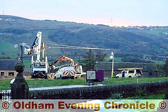 Castleshaw Valley: workman restore power