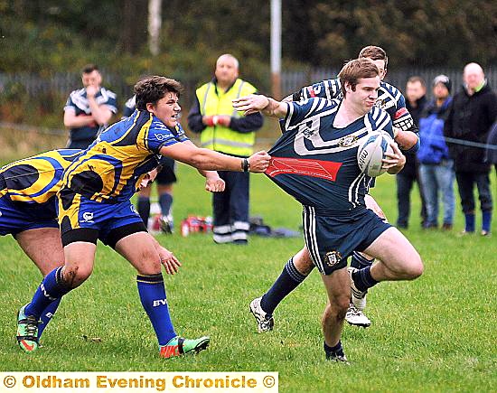 GETTING SHIRTY: Hollinwood’s Pete Davies grabbed by a Moorends Marauders rival.