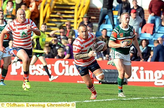 GREAT START: Steve Roper races over the line in the fifth minute to put Oldham ahead, before being mobbed. 