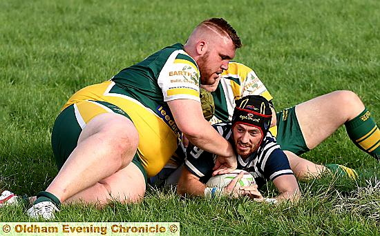 SQUEEZE: Hollinwood’s Jack Pemberton is held up just short of the line by two Hanging Heaton opponents. PICTURE: PAUL STERRITT