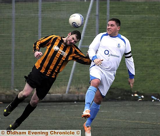 AERIAL DUEL: Carl Taylor (right), of Heyside, beats Kirkheaton Rovers rival Dan Harris to the ball. 