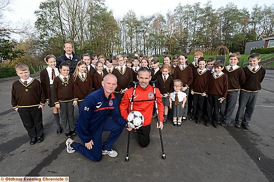 GUNNING FOR GLORY: Great Britain amputee coach Pete Wild (front, left) and player Dave Tweed are pictured with Year Six on a visit to St Joseph’s RC Primary School. GUNNING FOR GLORY: Great Britain amputee coach Pete Wild (front, left) and player Dave Tweed are pictured with Year Six on a visit to St Joseph’s RC Primary School.
