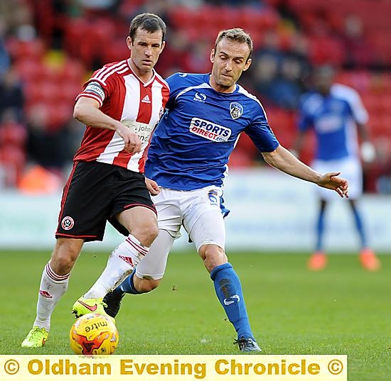 Liam Kelly shows the excellent defensive aspect of his game at the base of Athletic’s midfield.