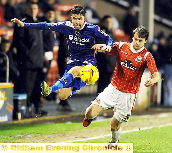 Athletic winger Mike Petrasso takes the aerial route to get past his marker. 