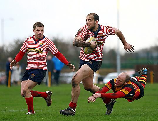 Martin Hamer burests clear of the Thornham defence