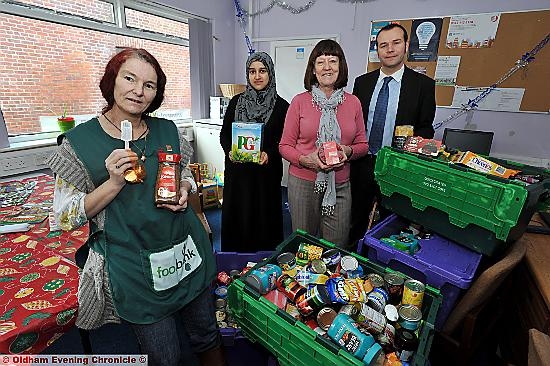 Merry Christmas (from left: Foodbank volunteer Lisa Leunig, Fateha Khano - Oldham Council Foodbank Co-ordinator, Councillor Barbara Brownridge, Simon Shuttleworth - Oldham Council Neighbourhoods Team)