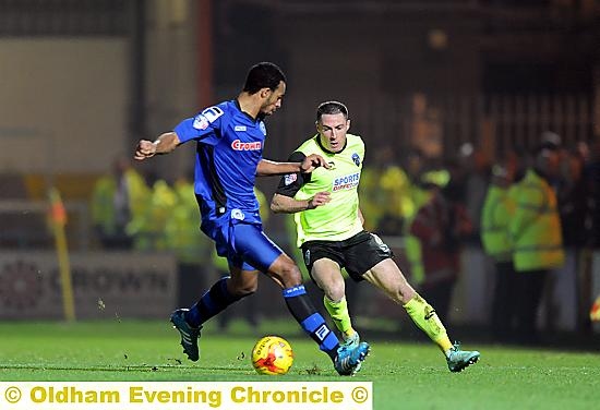 CLOSE QUARTERS . . . Athletic’s Mike Jones takes on Rochdale’s Rhys Bennett at Spotland.