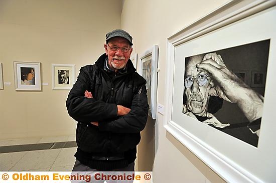 Artist Gordon Clegg with his exhibition of portraits, 'FACE - The World' at Gallery Oldham.