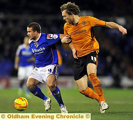 Midfielder James Wesolowski holds off a Wolves challenge 
