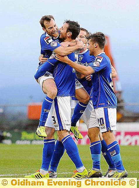 James Dayton jumps into the arms of Jonathan Grounds after the defender’s equaliser for Athletic. Pictures by VINCENT BROWN and ALAN HOWARTH 
