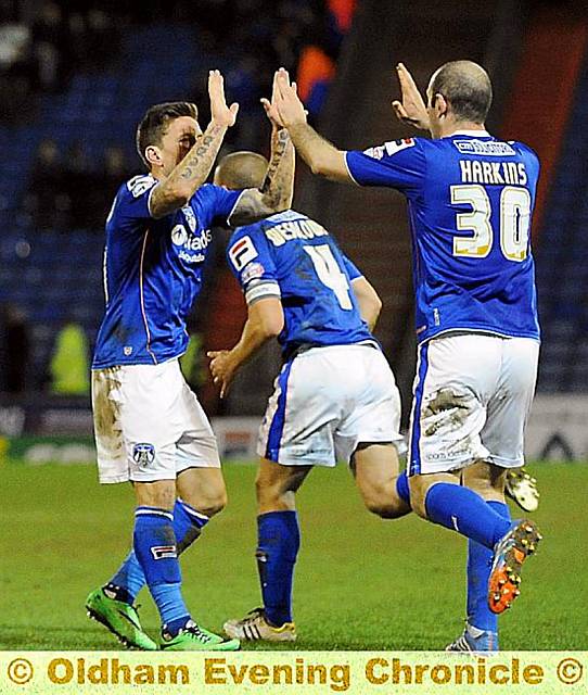 PUT IT THERE . . . Charlie MacDonald is congratulated on his goal by Gary Harkins. 