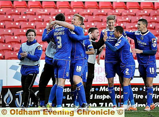 All in this together: new signing James Wilson (far right), Jon Stead (third, right) and John Paul Kissock (left) join in the celebrations after Jonathan Grounds’ winning goal against Swindon on Saturday. 
