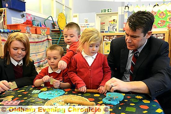 Failsworth school pupil Chloe Donnelly (left) shows Congressman Young her work as a role model to Thomas Waddington, Stuart Whelan and Maisie Lloyd. 

