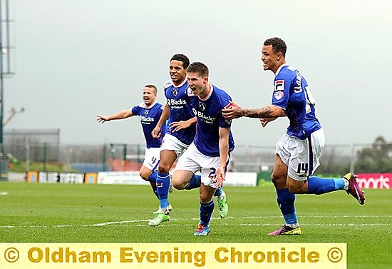 Danny Philliskirk celebrates his goal with his delighted team-mates. 