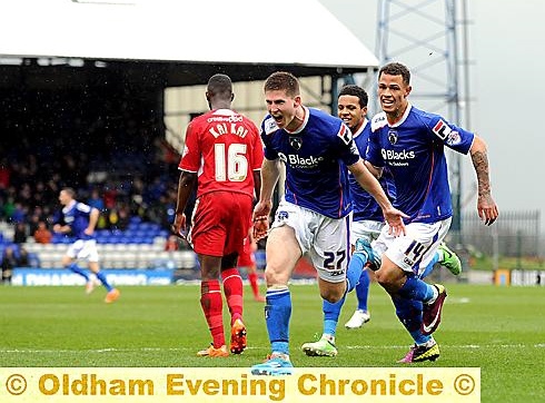 SMILES BETTER: Jonson Clarke-Harris (right) joins in Danny Philliskirk’s goal celebration against Crawley on Saturday. 