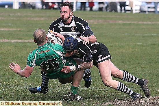 STOP THERE: Ryan Moores and Dave Newton, of Saddleworth Rangers, join forces to repel a Milford Marlins raid. STOP THERE: Ryan Moores and Dave Newton, of Saddleworth Rangers, join forces to repel a Milford Marlins raid.