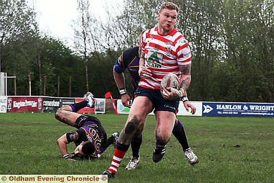 coming through: Oldham’s Ben Wood makes a charge for the Gateshead line. 