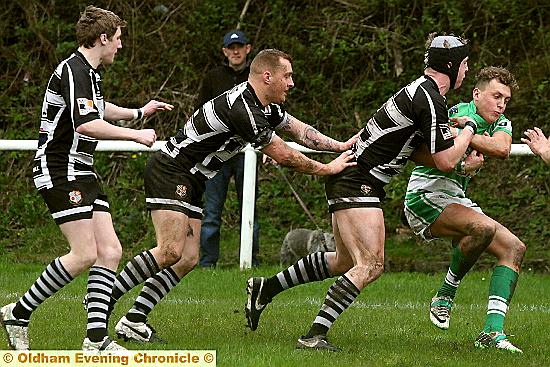 SADDLEWORTH Rangers trio Josh Bradbury, Dave Hewitt and Ethan Langhorn gang-up on Dewsbury Celtic’s Adam Egan. 
