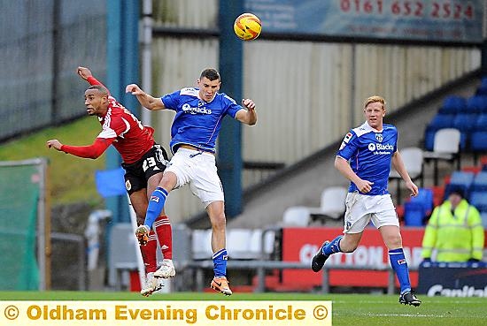 PAIR OF ACES: James Wilson, pictured heading the ball, and his defensive partner Adam Lockwood (right) have been a revelation since being introduced to the Athletic side. 
