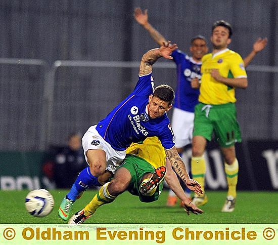 CHARLIE MacDonald goes down under a Sheffield United challenge