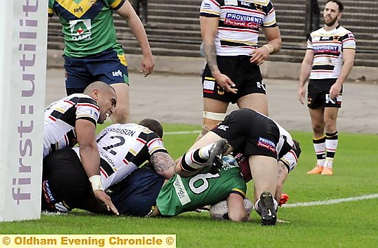 Kenny Hughes burrows his way across the line. 