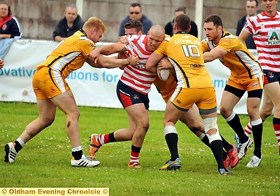 SHEER POWER: Josh Crowley carries the ball into the path of four South Wales defenders. 