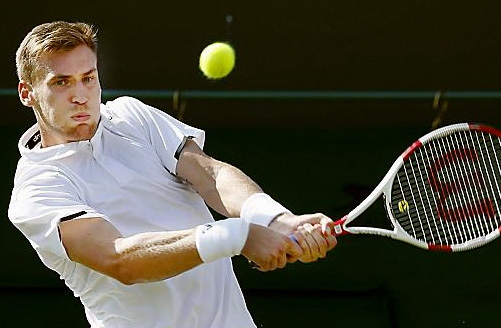 DANIEL Smethurst returns a John Isner serve.