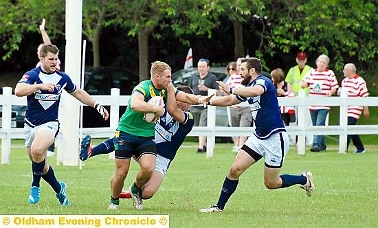 Danny Langtree pushes aside an Oxford opponent