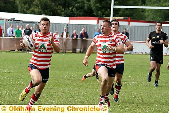 It takes two . . . Lewis Palfrey surges clear for Oldham’s second try.