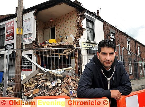 Shop owner Kabir Ahmed outside his damaged premises.