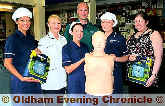 Kitchen staff Caroline Vongeyer, Lauren Kelly, Ashleigh Chastney, Pam Morris, school nurse Kat Watson and Steve Nicholls with the new defibrillators and a dummy