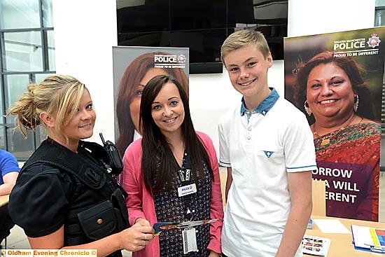 Jobs Fair and 5-a-side football match at North Chadderton School, both organised by Greater Manchester Police. Left to right at the jobs fair, PCSO Rhiannon Ashworth, Sophie Sowerby (operations support officer), Jack Radford (15) from Blue Coat School.