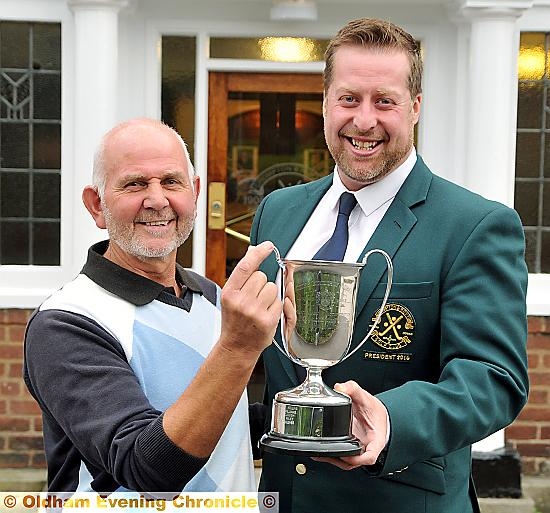 IT’S MINE: Stuart Hopkinson receives the Centenary Trophy from Crompton and Royton president Stuart J Whittle.