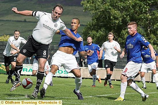 TOUGH TIMES: Mossley’s Andy Keogh (left) is tackled.